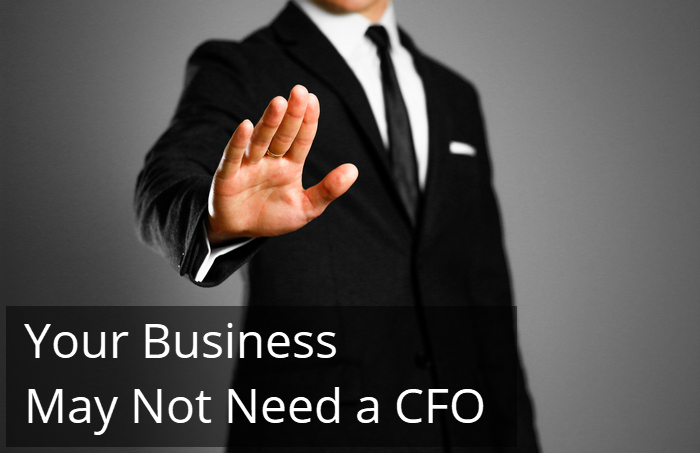 A man in a suit holding up his hand beside the words Your Business May Not Need a CFO.