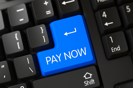 A computer keyboard with a blue key labeled Pay Now.