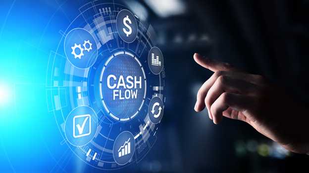 A hand touching a glowing circular interface centered on the words Cash Flow.
