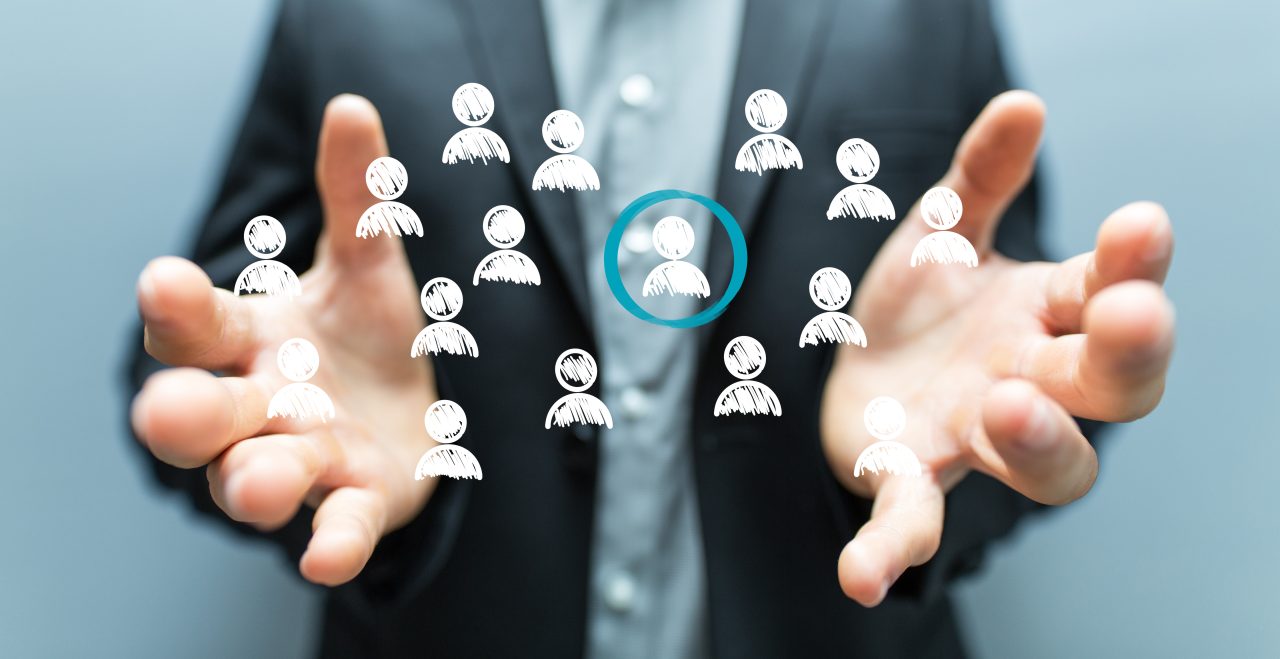Open hands beneath floating person icons with one candidate highlighted.
