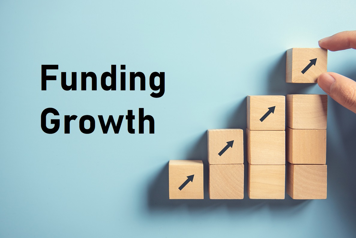 A hand placing the top block on a rising staircase of blocks marked with arrows, beside the words Funding Growth.
