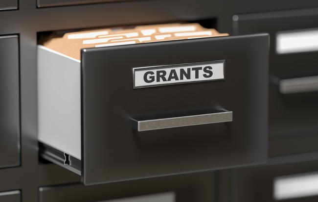 An open filing cabinet drawer labeled Grants.