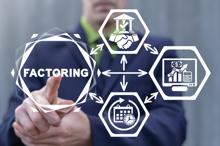 A businessman touching a diagram of hexagon icons surrounding the word Factoring.