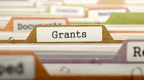 A file folder tab labeled Grants among rows of office folders.