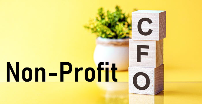 Wooden blocks spelling CFO beside the words Non-Profit on a yellow background.