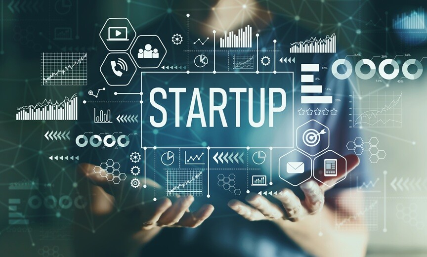 Open hands beneath the word Startup surrounded by digital business icons.