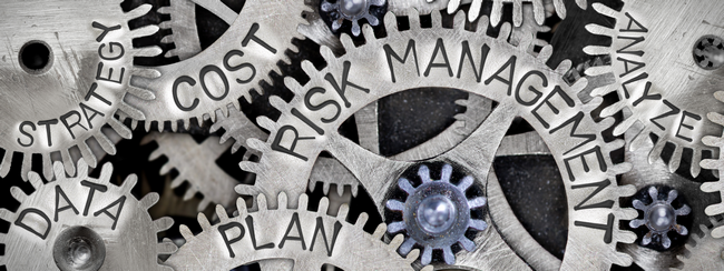 Interlocking gears labeled with planning terms including risk management, strategy and cost.