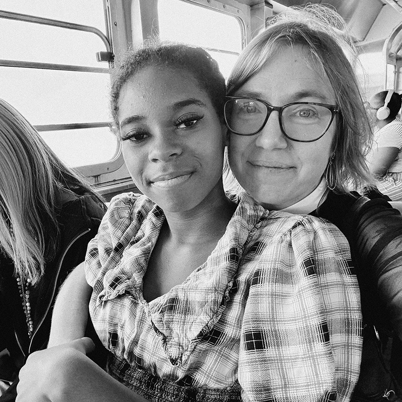 A woman and a teenage girl smiling together, supporting the Adoptee Mentoring Society.