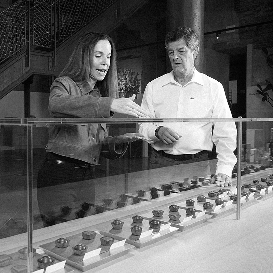 Kurt Maass of CFO Selections and Andrina Bigelow of Fran's Chocolates at a chocolate display case.