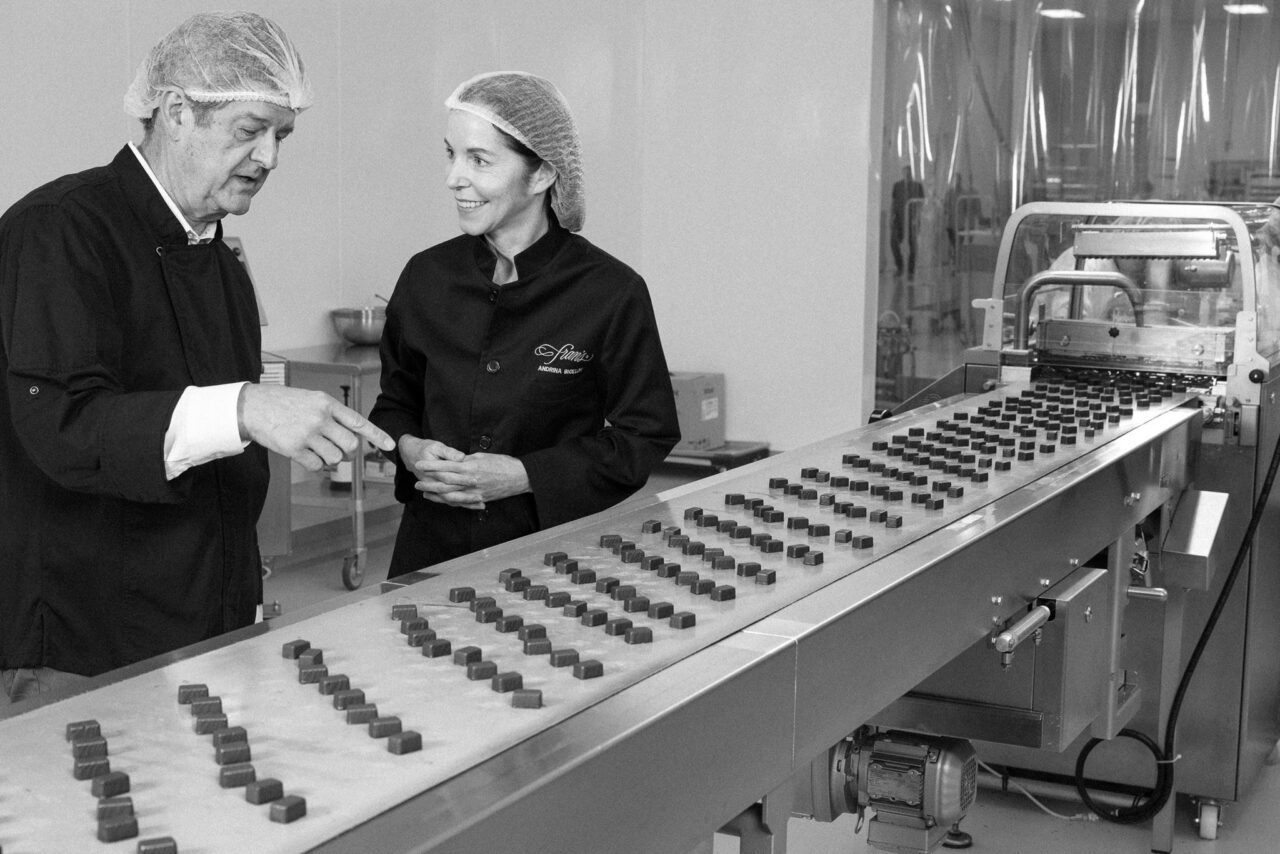 Kurt Maass and Andrina Bigelow at the chocolate production line at Fran's Chocolates
