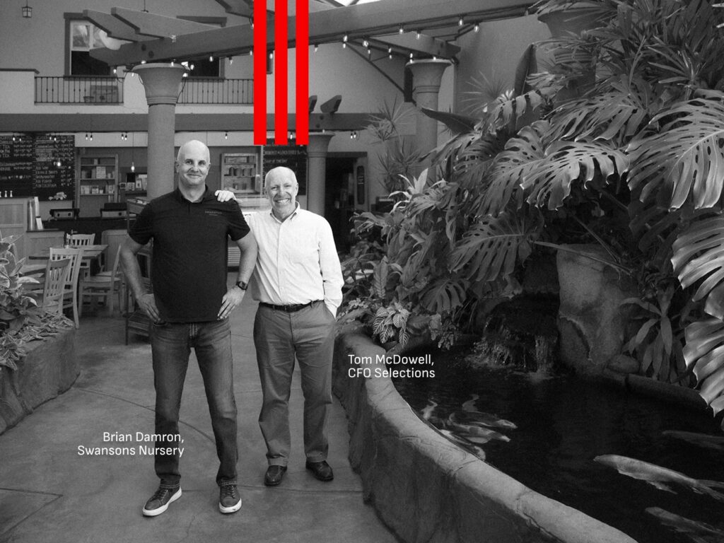Fractional CFO Tom McDowell with Swansons Nursery owner Brian Damron by the koi pond